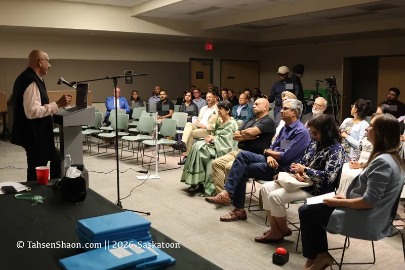 A talk at the podium, with the audience in the auditorium at Alice Turner Library